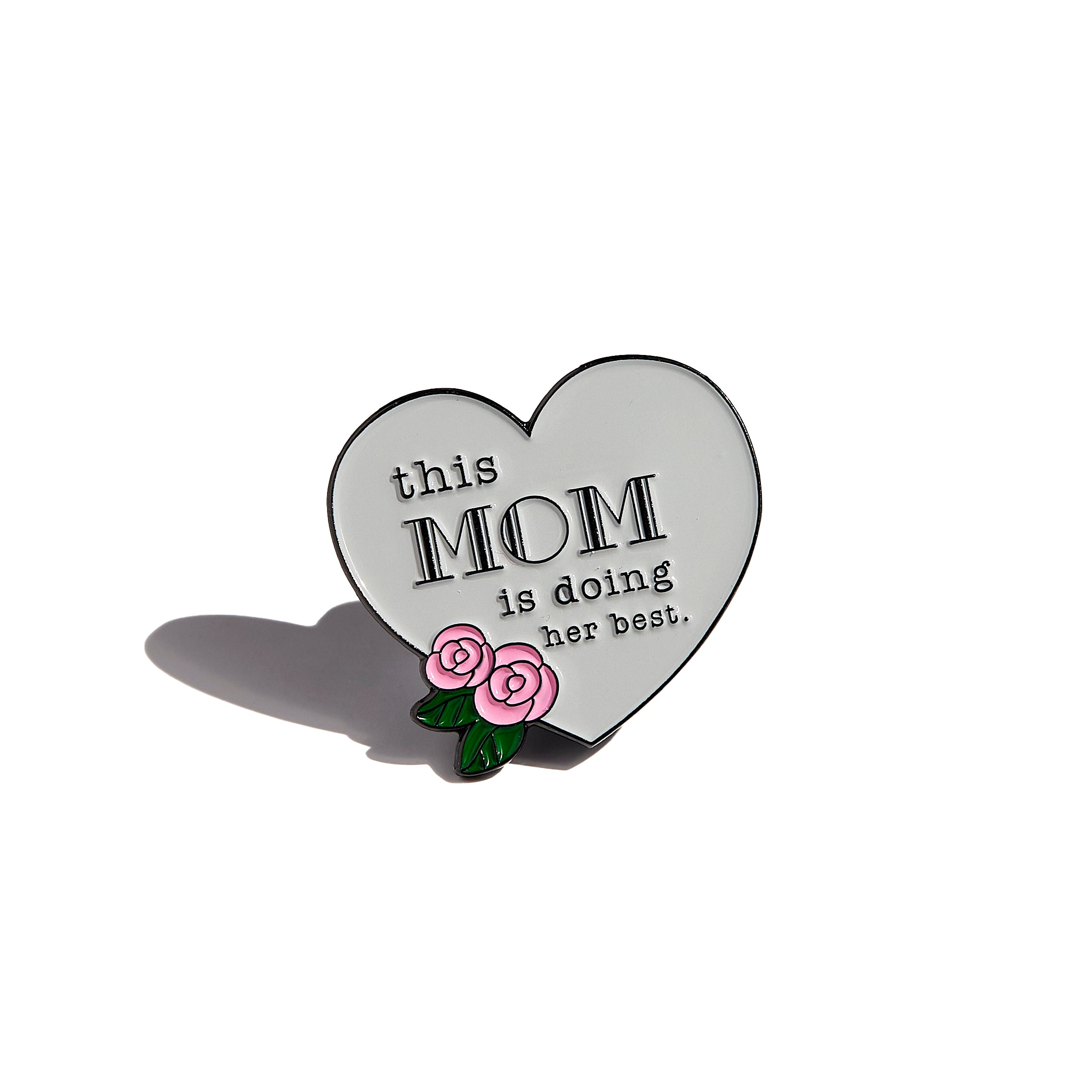 Close-up of intricately designed Mom Crew pins, perfect for accessorizing