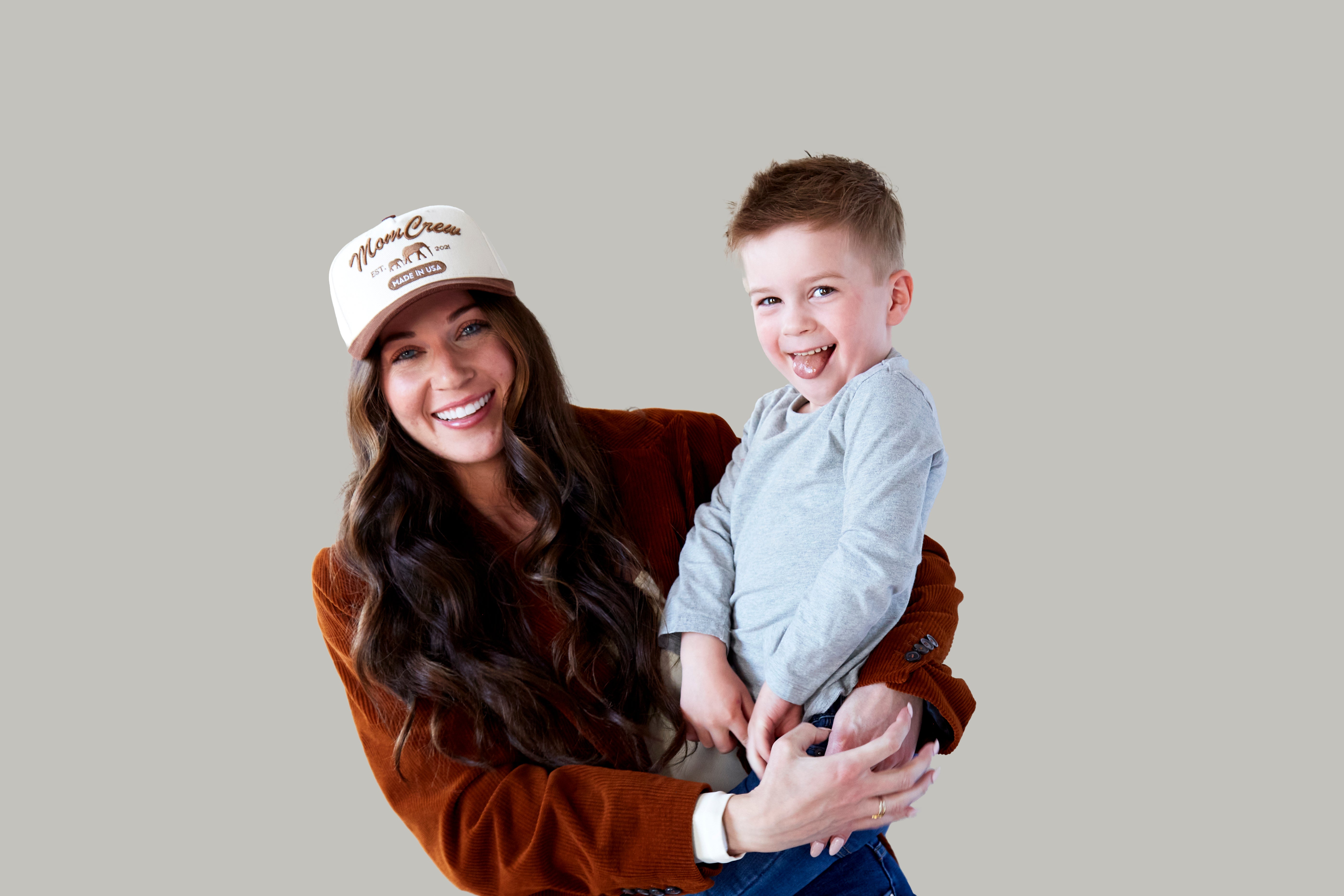 The MomCrew Rancher Cap is a stylish cap crafted from a blend of 100% cotton and corduroy, featuring the iconic MomCrew embroidered logo. It's designed with an adjustable snap closure, making it a comfortable and customizable fit for both moms and dads. Ideal for those who appreciate a western-inspired look with a modern twist, this cap blends durability with style, making it perfect for everyday wear.