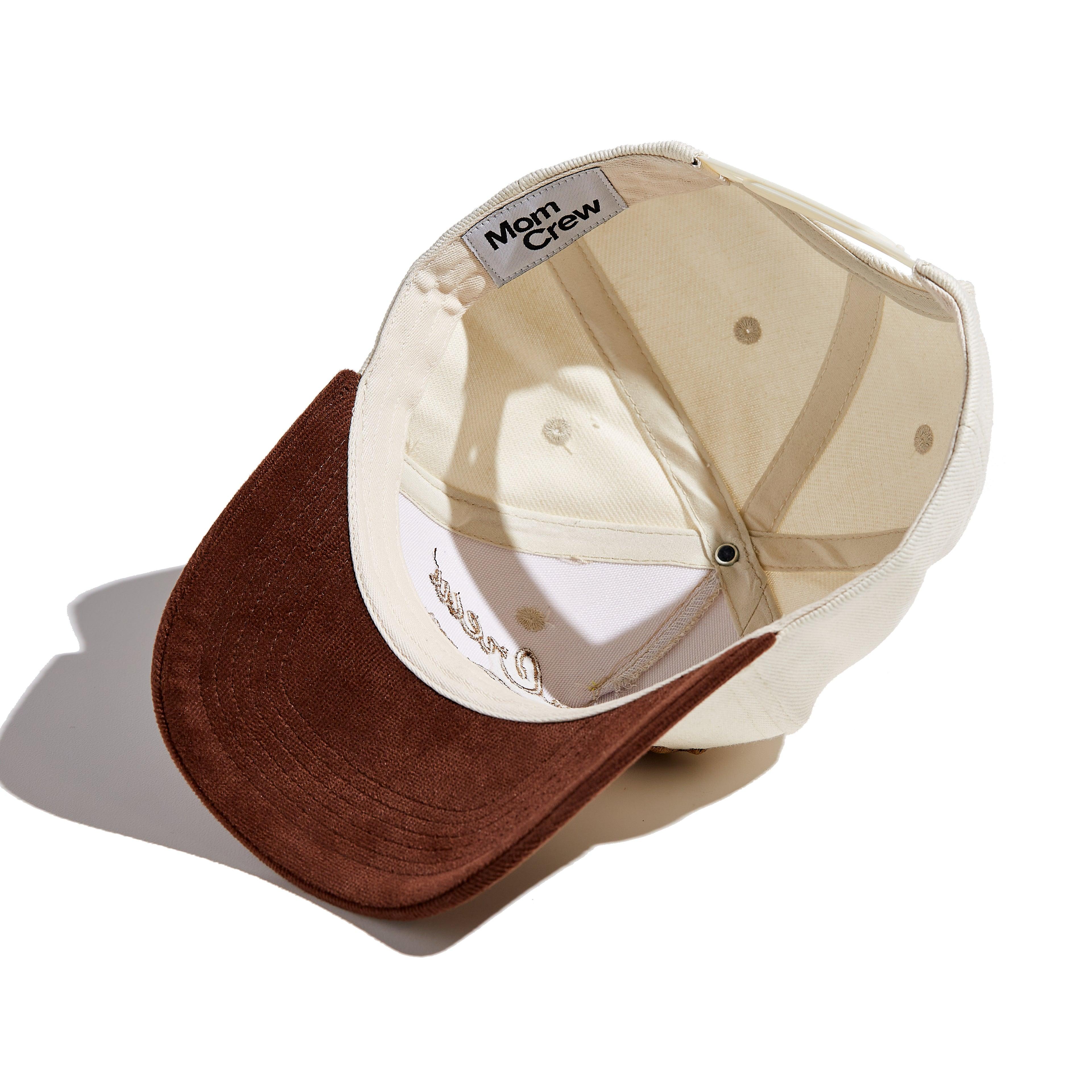 The MomCrew Rancher Cap is a stylish cap crafted from a blend of 100% cotton and corduroy, featuring the iconic MomCrew embroidered logo. It's designed with an adjustable snap closure, making it a comfortable and customizable fit for both moms and dads. Ideal for those who appreciate a western-inspired look with a modern twist, this cap blends durability with style, making it perfect for everyday wear.