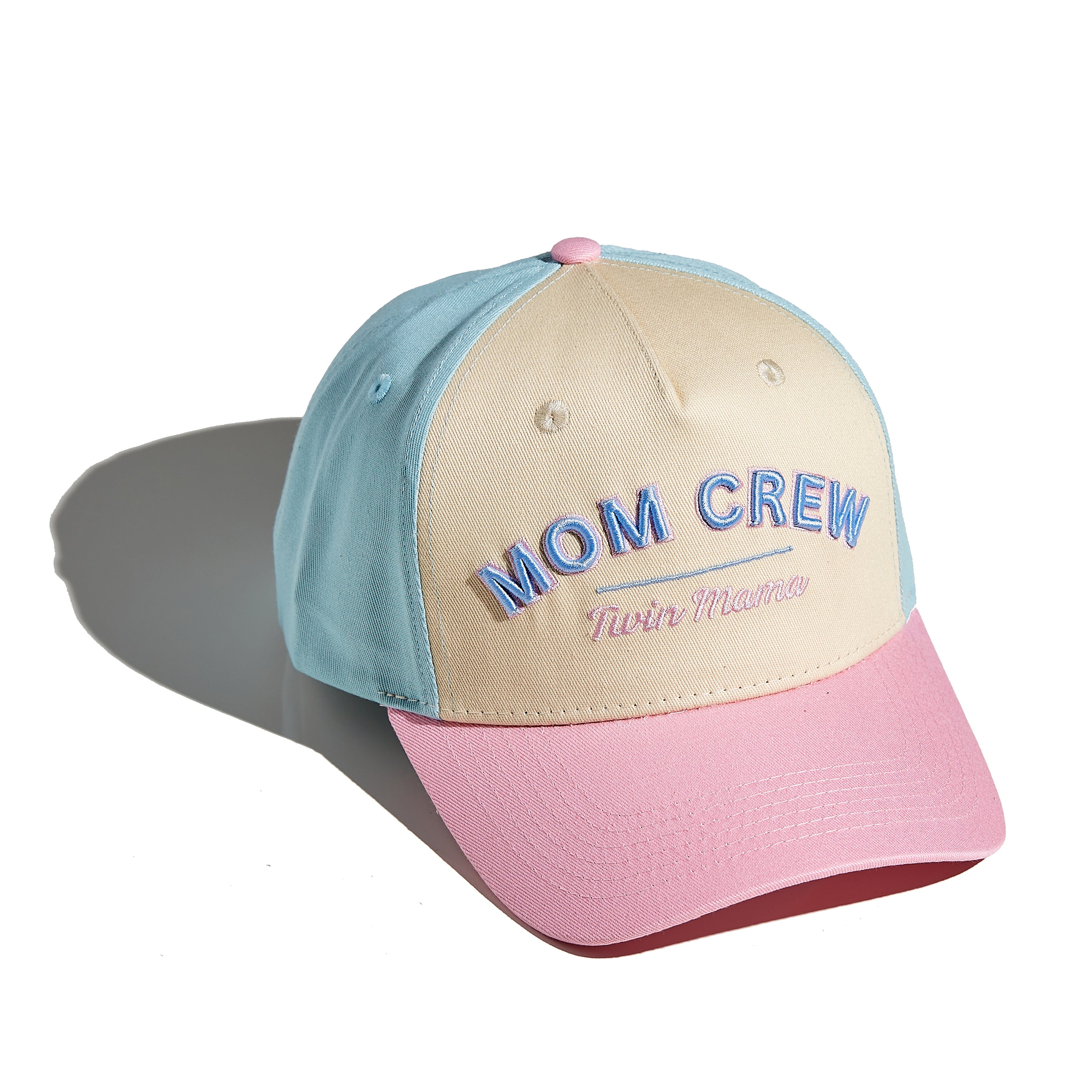 The MomCrew TWIN MAMA Cap is designed for proud moms of twins, featuring bold "TWIN MAMA" embroidery. This 100% cotton cap combines style and comfort, with an adjustable snap closure for a customized fit. It's perfect for busy days with your dynamic duo, offering a sleek and practical design suitable for both moms and dads.