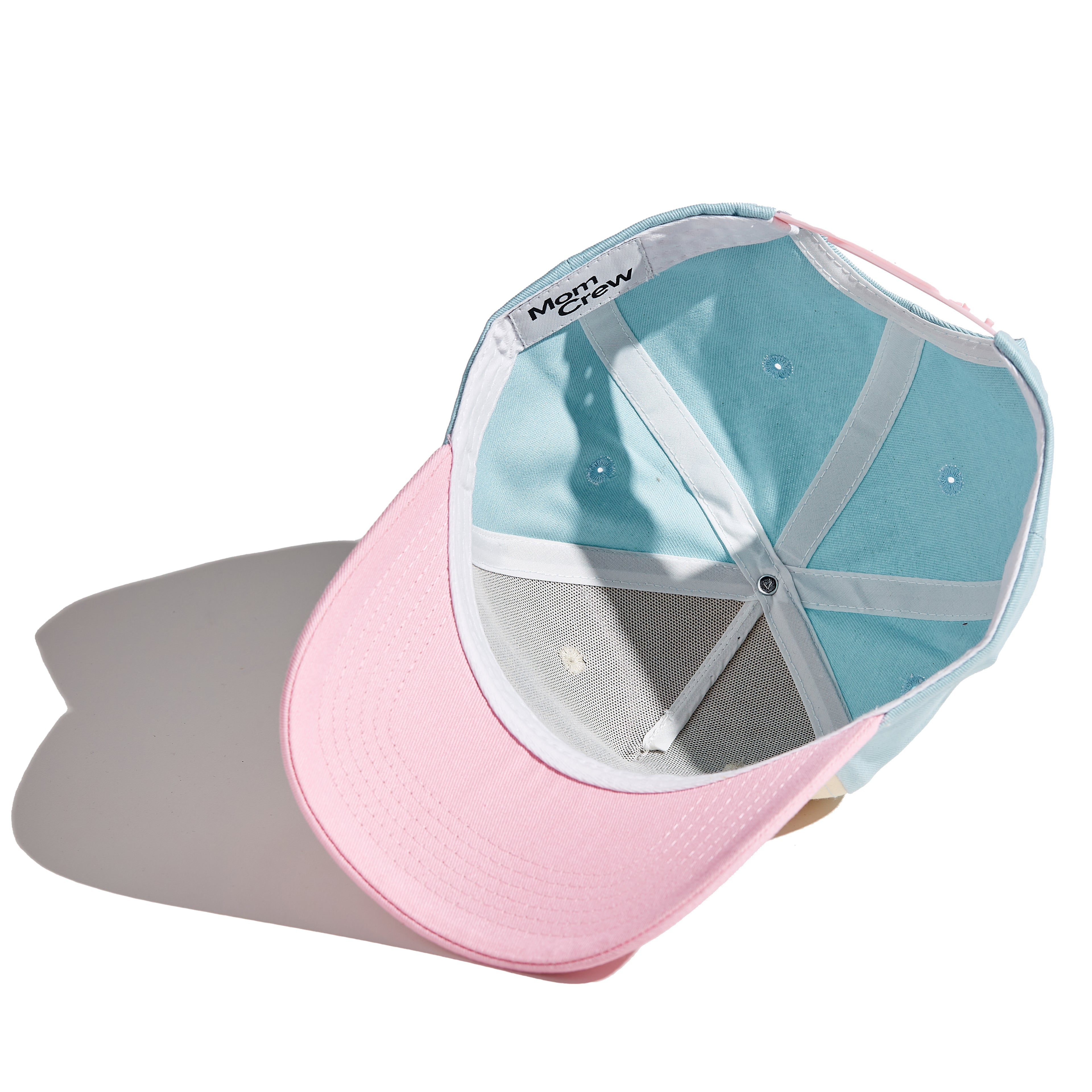 The MomCrew TWIN MAMA Cap is designed for proud moms of twins, featuring bold "TWIN MAMA" embroidery. This 100% cotton cap combines style and comfort, with an adjustable snap closure for a customized fit. It's perfect for busy days with your dynamic duo, offering a sleek and practical design suitable for both moms and dads.