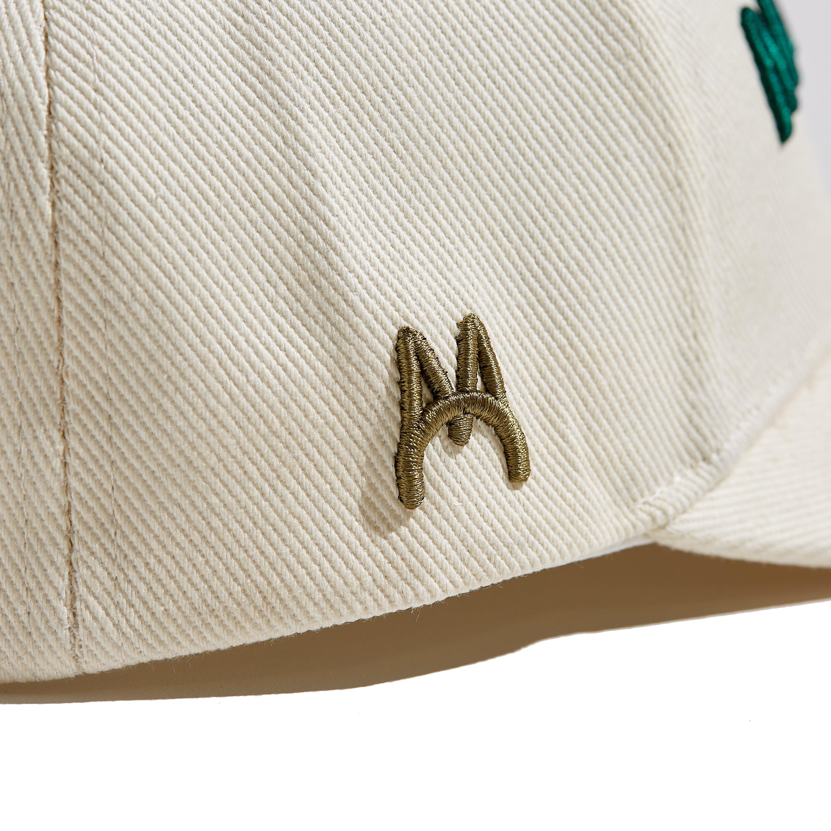 The MomCrew Essential Cotton Cap is a versatile and stylish accessory made from 100% cotton. It features the signature green MomCrew embroidered logo on the front and an adjustable snap closure for a custom fit, making it suitable for both moms and dads. This cap is perfect for everyday wear, combining comfort and durability, and is designed to fit most head sizes.