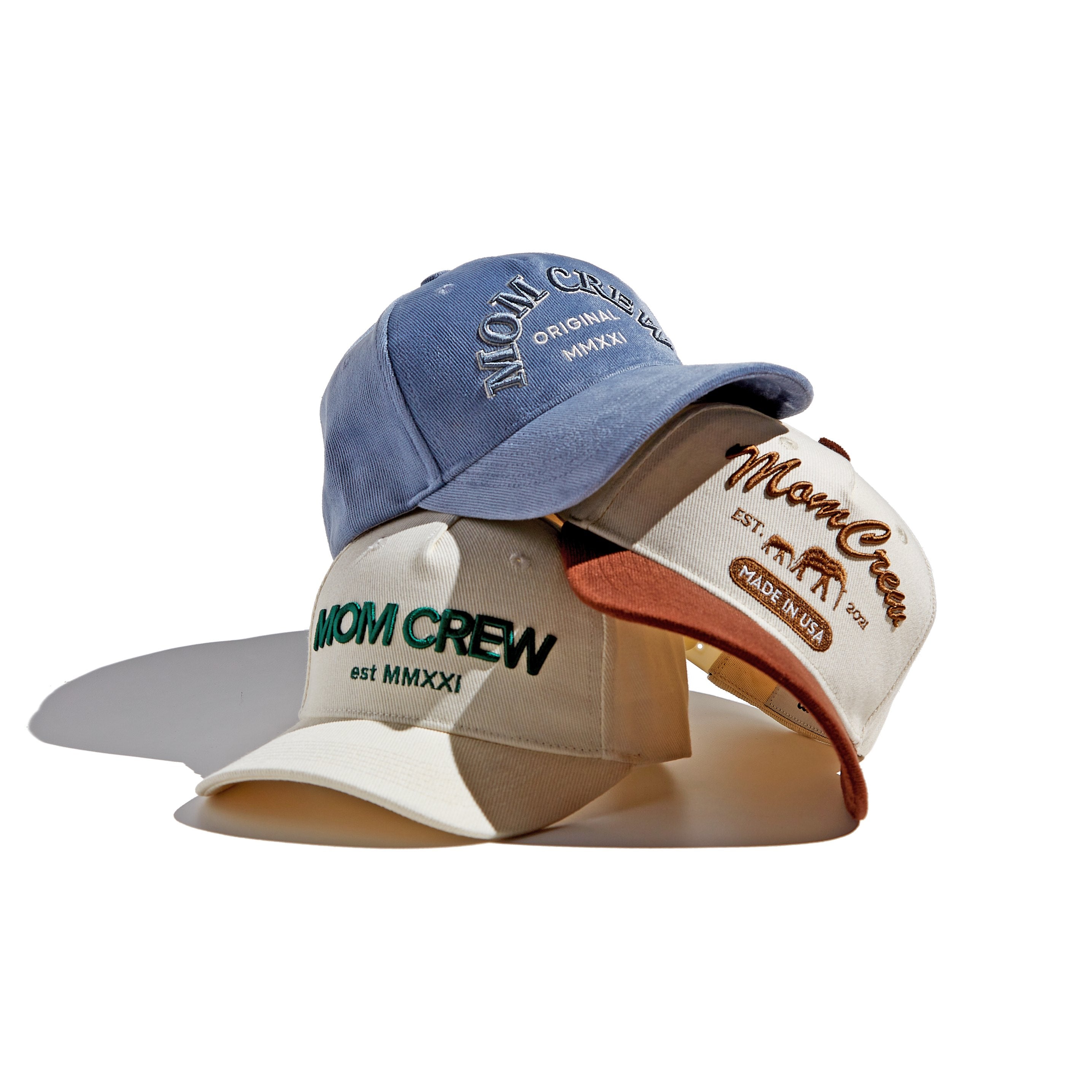 The MomCrew Triple Joy Cap Bundle includes three stylish caps: the Essential Cotton Cap, Classic Corduroy Cap, and Rancher Cap. Each cap features the signature embroidered logo and an adjustable snap closure for a perfect fit, offering comfort and style for both moms and dads.